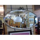 OVAL MIRROR IN METAL FRAME WITH BEVELLED GLASS