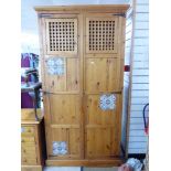 2 DOOR PINE CUPBOARD WITH DECORATIVE CERAMIC PLAQUES 2.13 X 1.05 X 36 CMS