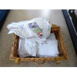 LARGE QUANTITY OF LINEN IN A WICKER PICNIC HAMPER