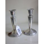 PAIR OF WEIGHTED HALL MARKED SILVER CANDLESTICKS 13 CMS HIGH