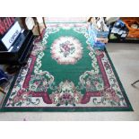 GREEN & RED RUG. 284 X 189 CMS