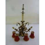 A four branch gilt metal candelabra with detachable red shades, A/F