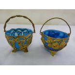 Two French gilt metal baskets with swing handles and detachable blue glass liners, A/F