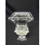 A decorative glass rectangular vase on raised rectangular plinth