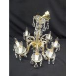 A cut glass chandelier with eight scrolling arms and crystal drops, A/F