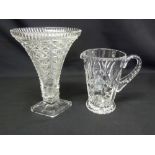 An Art Deco style cut glass vase on raised square base and a cut glass jug