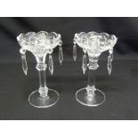 A pair of clear cut glass lustres on circular spreading bases