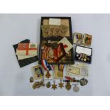 A quantity of WWI and WWII medals, badges and bars