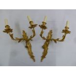 A pair of Art Nouveau style gilded metal two branch wall lights