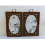 A pair of Chinese porcelain panels of floral decorations in hardwood frames, 49.5 x 31.5cm