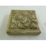 A Persian white metal square box, the hinged cover embossed with birds and flowers on four bracket