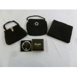 Three black ladies evening bags and a Stratton compact in original packaging