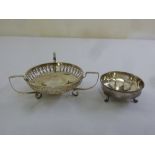 A silver three handled dish with pierced sides A/F and a silver nut dish on three claw feet