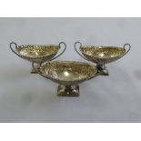 Three Victorian silver oval salts with side handles on rectangular bases, Sheffield 1895