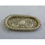 A silver oval pin tray chased with flowers and C scrolls, Birmingham 1927