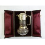 A Victorian silver and glass claret jug, the glass body etched with vines, the silver mount chased