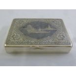 A Far Eastern white metal and niello work cigarette box, the hinged cover depicting ships on a lake