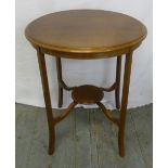 An Edwardian circular mahogany side table on four outswept legs