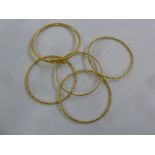 Five gold bangles, tested 21ct, approx total weight 53.9g