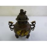 A Chinese early 20th century bronze incense burner with lion finial to domed cover