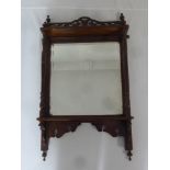 A late Victorian rectangular mahogany, carved and pierced wall mirror