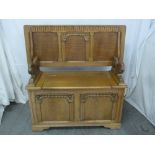 Reproduction oak Monks bench, two lion carved side handles with hinged seat and back