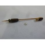 A 9ct gold tie pin set with a garnet and a diamond and a loose diamond