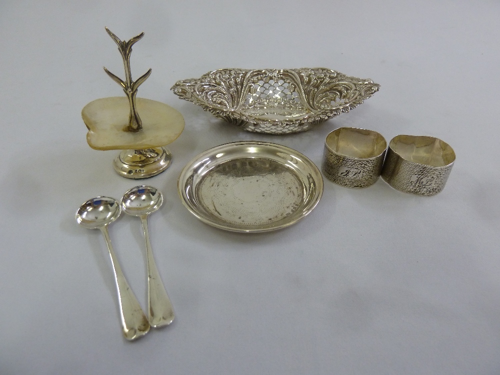 A silver hallmarked shaped oval bonbon dish and two napkin rings, two condiment spoons, a coaster