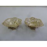 A pair of Victorian silver bonbon dishes, shaped circular, pierced sides on scroll pierced square