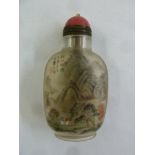 A Chinese early 20th century reverse painted snuff bottle decorated with landscapes