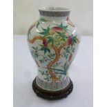 A Chinese 20th century baluster vase decorated with fruit, trees and leaves, marks to the base