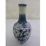 A Chinese early 20th century blue and white vase decorated with bats and dragons