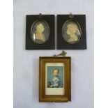 Two framed wax miniatures of a man and a woman in profile and another framed miniature