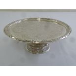 A Continental white metal tazza, circular on raised circular base, engraved with flowers and