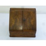 A late Victorian rectangular walnut desktop stationery cabinet the hinged doors revealing fitted