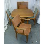 Skovby of Denmark teak dining table with two drop in leaves on triform base and four chairs, (one