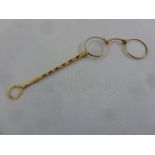 A pair of French gold lorgnette, set with garnets, approx total weight 32.1g
