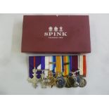 A mounted collection of military medals to include an MBE, a Military Cross, a 1914 Star with bar