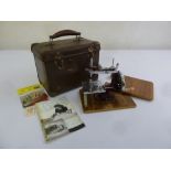 An Essex miniature sewing machine in original fitted case