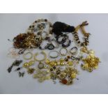 A quantity of costume jewellery to include necklaces, brooches, bangles, pendants and watches