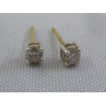 A pair of 18ct yellow gold and diamond claw set earrings, approx total weight 0.7g, diamonds