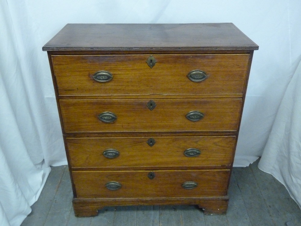 A mahogany four drawer campaign chest of drawers with brass handles on four bracket feet