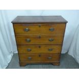 A mahogany four drawer campaign chest of drawers with brass handles on four bracket feet