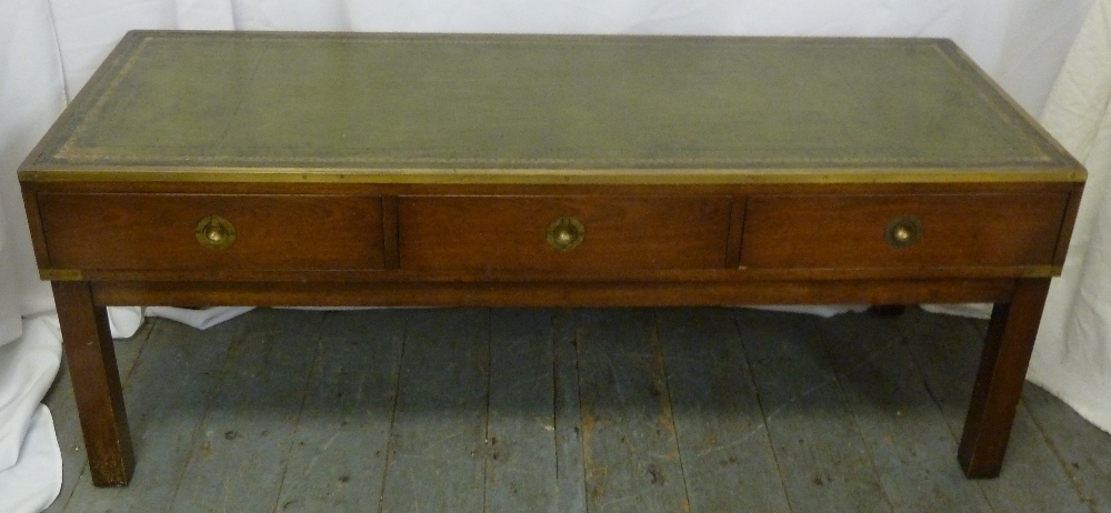 A mahogany brass bound campaign table, rectangular with tooled leather top, three drawers, on four