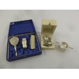 A silver tea strainer and stand, a white metal cased Christening set and a cased white metal