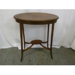 An Edwardian oval side table on four tapering legs