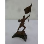 A bronze figurine of a 19th century soldier holding a flag on raised marble base, signed to the