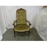 A Victorian mahogany upholstered ladies button back armchair on four cabriole legs