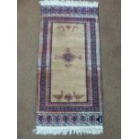 A Middle Eastern wool carpet brown ground with red and blue pattern and repeating border, 150 x