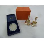 A Halcyon Days cased enamel picture frame and a pair of Halcyon Days silver plated candle sticks